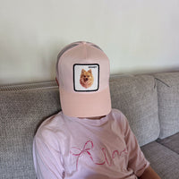 Pastel pink trucker cap with a custom Pomeranian portrait patch